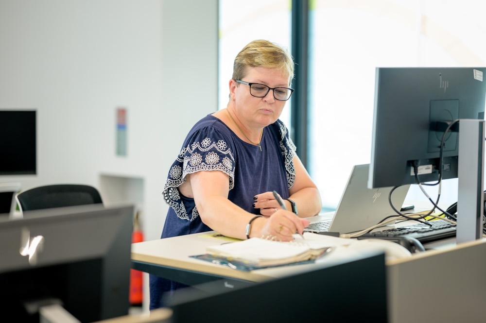 Accountant reviewing company records at her desk